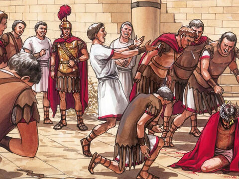 (Mt 27,27–31) Dann nahmen die Soldaten des Statthalters Jesus mit in das Prätorium und versammelten um ihn die ganze Schar; und sie zogen ihn aus und legten ihm einen scharlachroten Mantel um. Und sie flochten eine Krone aus Dornen und setzten sie auf sein Haupt und gaben ihm ein Rohr in seine Rechte; und sie fielen vor ihm auf die Knie und verspotteten ihn und sagten: Sei gegrüßt, König der Juden! – Folie 1